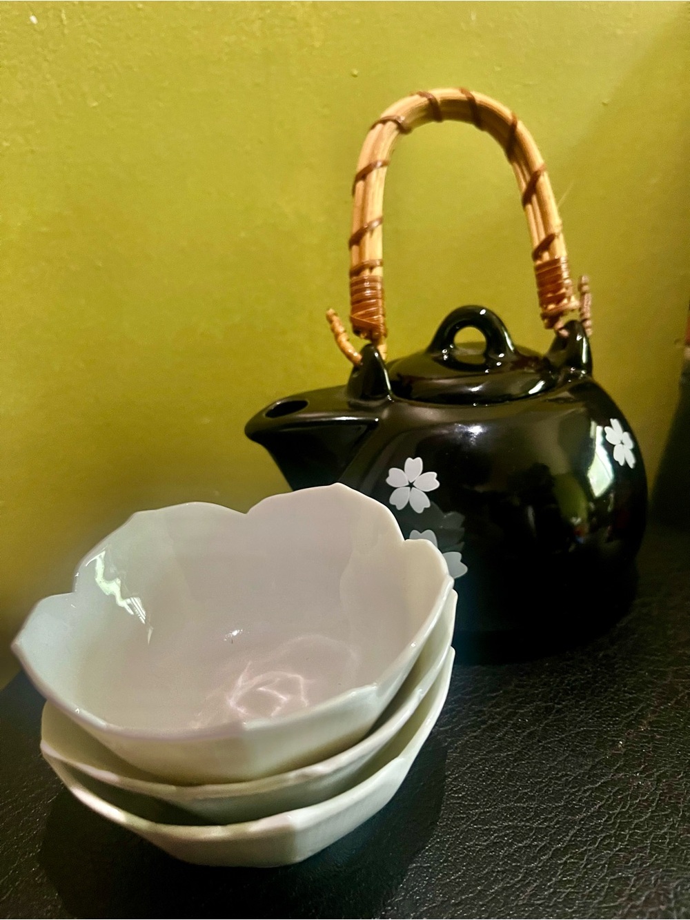 Black Floral Ceramic Teapot with Bamboo Handle and White Blossom Bowls